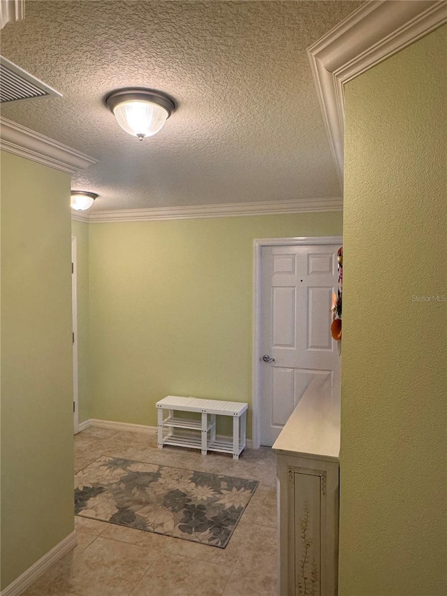 hallway featuring light tile patterned floors, a textured ceiling, and ornamental molding