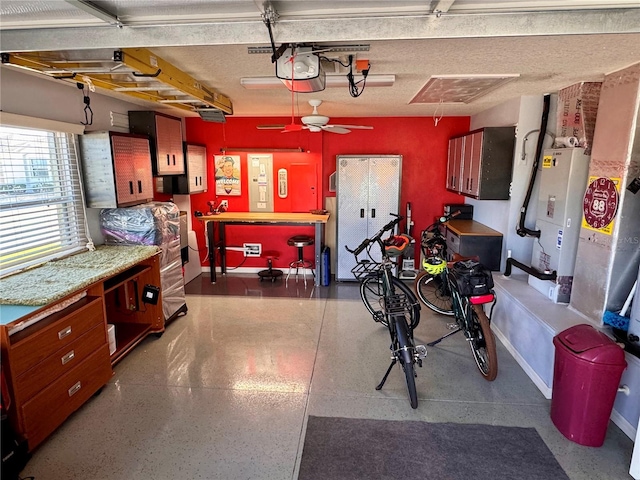 garage featuring a workshop area, ceiling fan, and a garage door opener