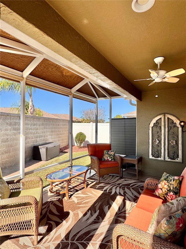 sunroom featuring ceiling fan