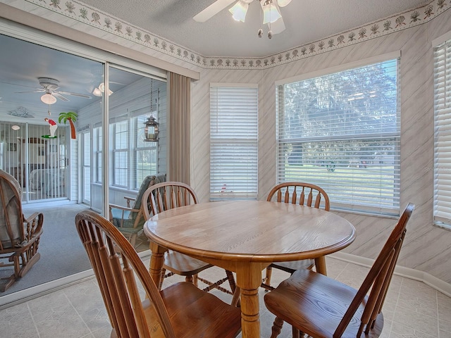 dining area with a textured ceiling and ceiling fan