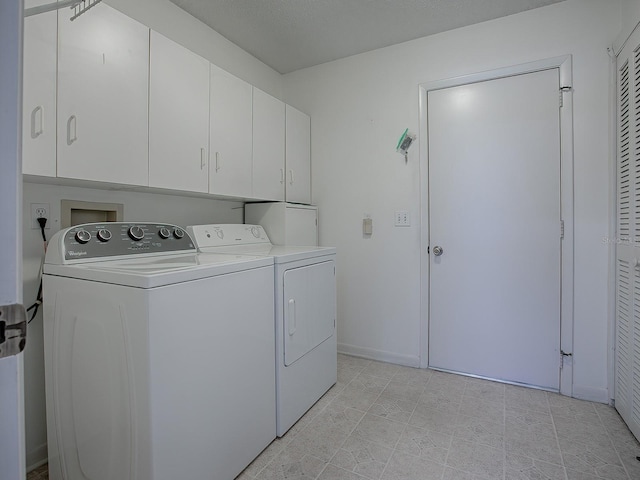 washroom with independent washer and dryer and cabinets