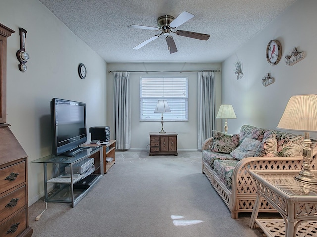 carpeted living room with a textured ceiling and ceiling fan