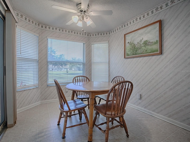 dining room with ceiling fan and a textured ceiling