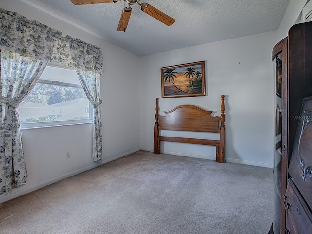 interior space with ceiling fan and a textured ceiling