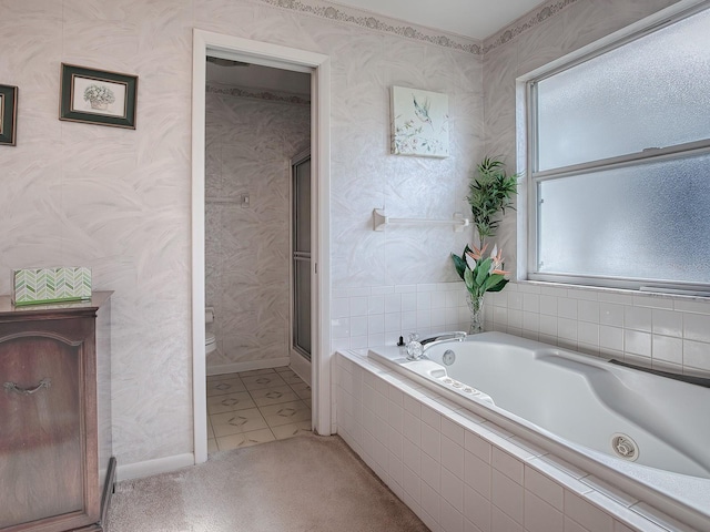 bathroom featuring shower with separate bathtub, a wealth of natural light, tile patterned floors, and toilet