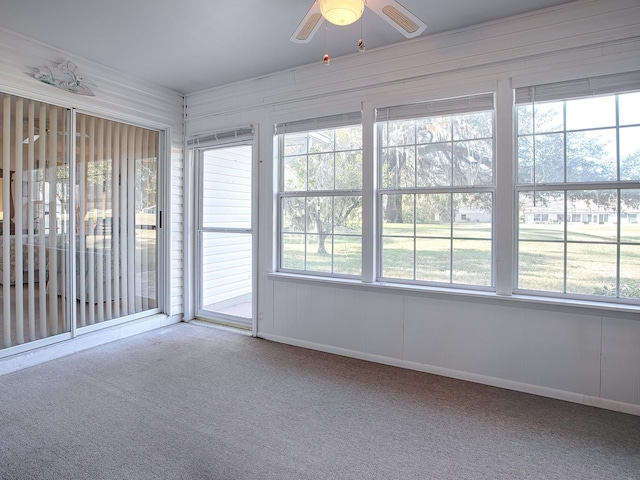 unfurnished sunroom with ceiling fan and a wealth of natural light