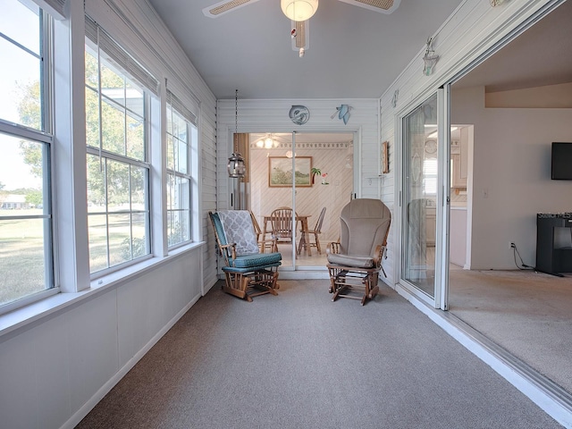 sunroom / solarium featuring ceiling fan