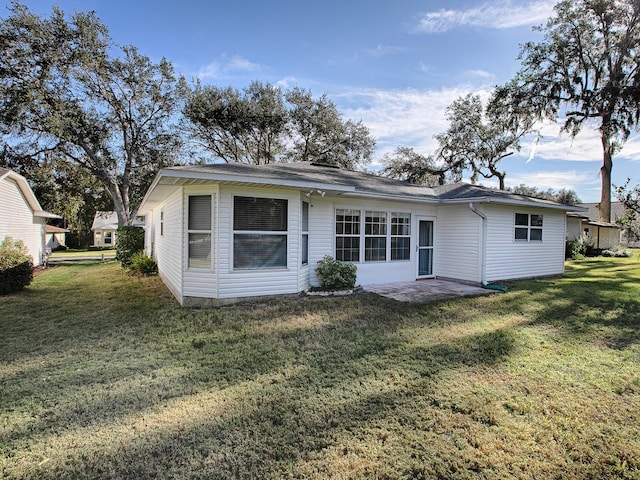 back of house with a yard