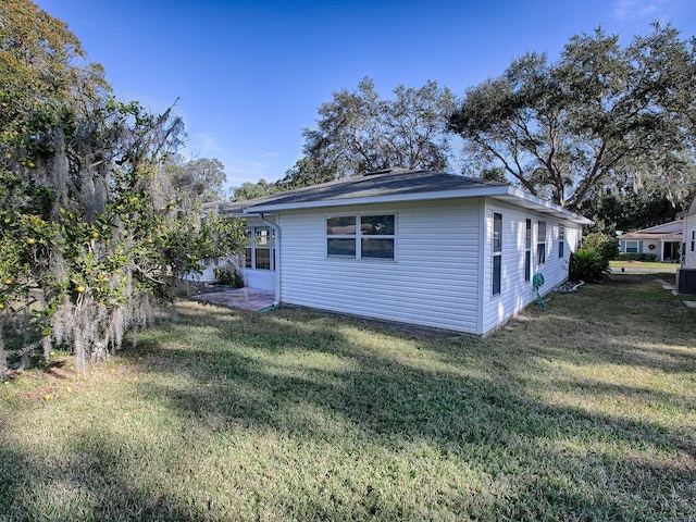 view of home's exterior with a yard and cooling unit