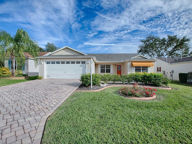 ranch-style home featuring a garage and a front lawn