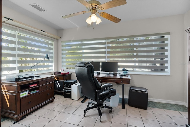 office with plenty of natural light, ceiling fan, and light tile patterned flooring