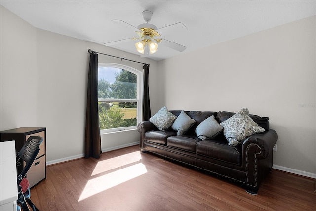 living room featuring wood-type flooring and ceiling fan