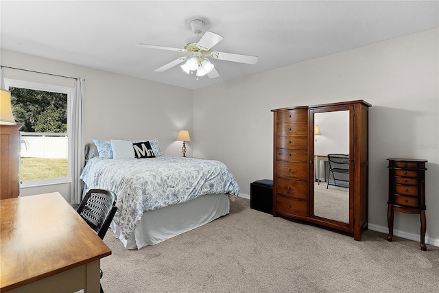 bedroom featuring ceiling fan and light carpet