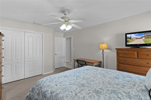 carpeted bedroom with a closet and ceiling fan