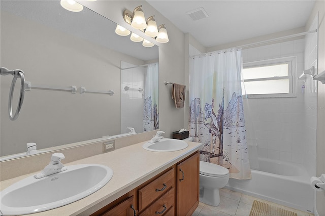 full bathroom featuring vanity, tile patterned floors, shower / bath combo with shower curtain, and toilet