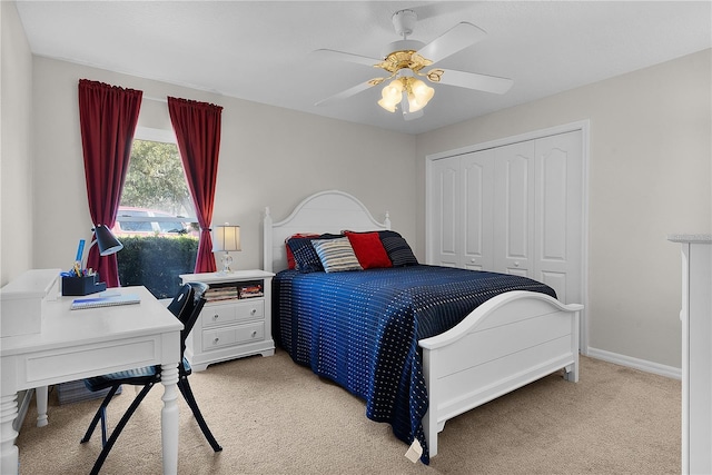 carpeted bedroom with ceiling fan and a closet