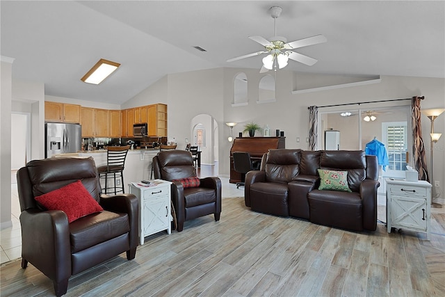 living room with lofted ceiling, light hardwood / wood-style floors, and ceiling fan