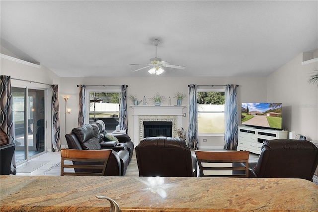 dining room with a wealth of natural light, vaulted ceiling, and ceiling fan