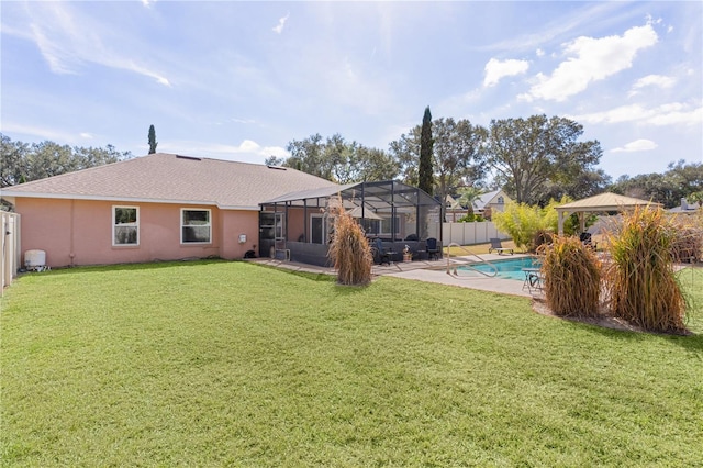 back of house with a fenced in pool, a gazebo, a yard, and a lanai