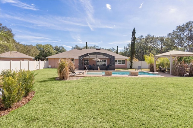 back of house featuring a fenced in pool, a gazebo, a lanai, and a yard