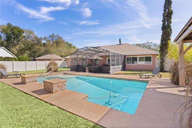 view of swimming pool with a patio, a yard, and glass enclosure