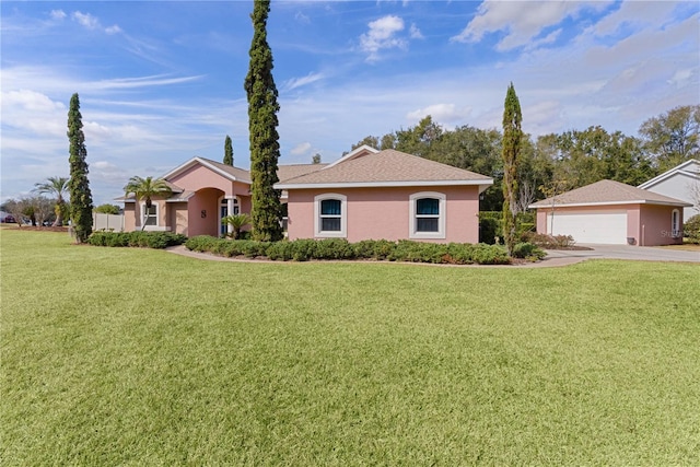 ranch-style home with a garage and a front yard