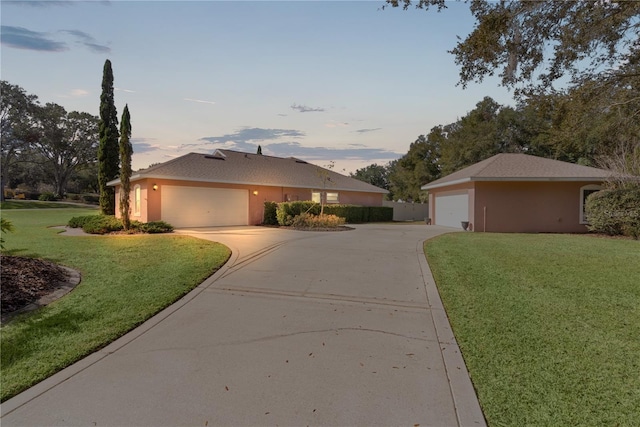 view of front of home with a garage and a yard