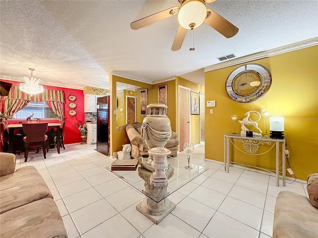 tiled living room featuring ceiling fan with notable chandelier, ornamental molding, and a textured ceiling