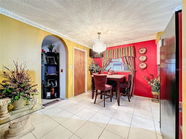 dining room featuring tile patterned floors, crown molding, a chandelier, and a textured ceiling