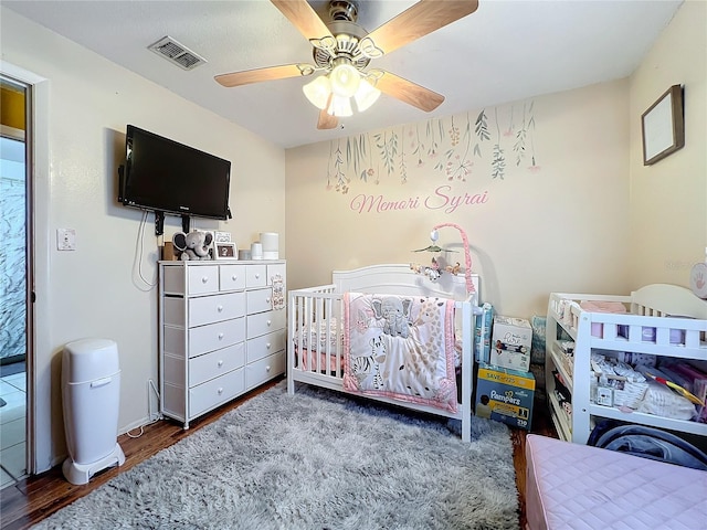 bedroom featuring ceiling fan and dark wood-type flooring