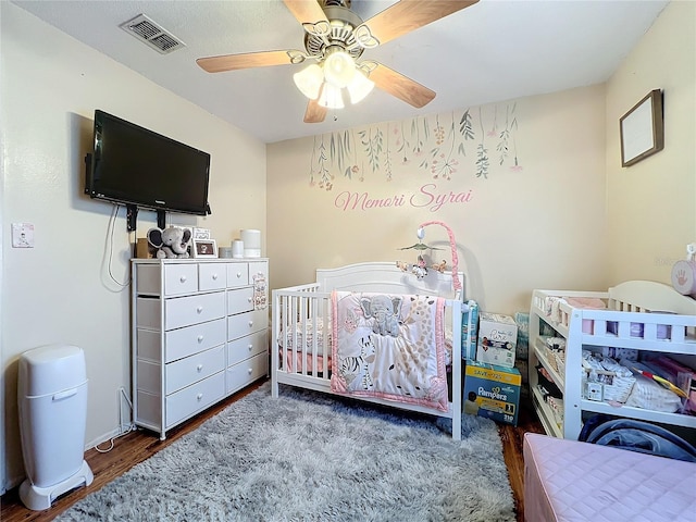 bedroom with ceiling fan and dark hardwood / wood-style floors