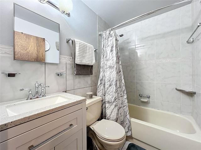 full bathroom with vanity, toilet, tile walls, and shower / tub combo