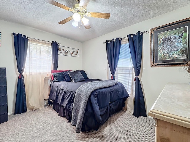 bedroom with light carpet, a textured ceiling, and ceiling fan