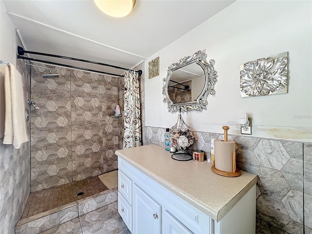 bathroom with a shower with shower curtain, vanity, and tile walls