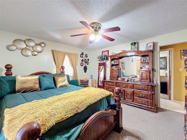 carpeted bedroom with a textured ceiling and ceiling fan