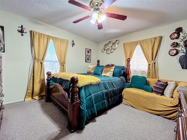 carpeted bedroom with multiple windows, ceiling fan, and a textured ceiling