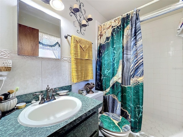 bathroom with a shower with shower curtain, vanity, toilet, and tile walls