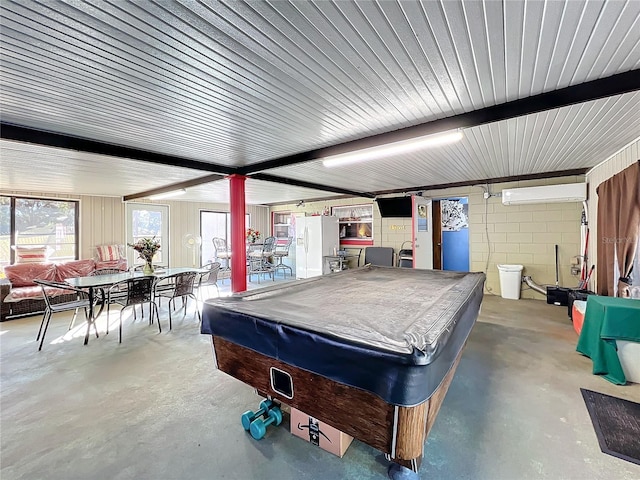 playroom featuring a wall unit AC, beamed ceiling, concrete floors, and billiards