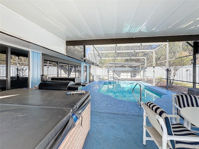 view of pool featuring glass enclosure and a patio