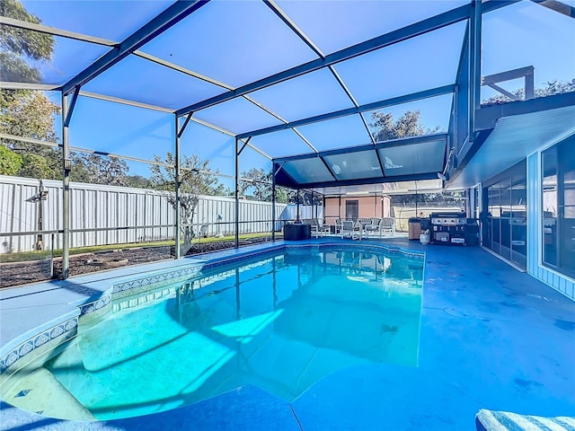 view of swimming pool with a patio and glass enclosure