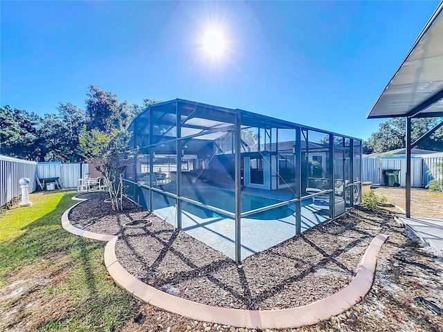 view of pool with glass enclosure and a patio