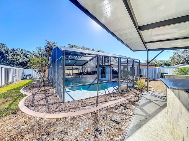 view of swimming pool featuring a lanai