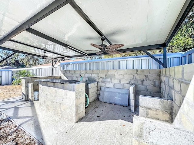 view of patio / terrace with ceiling fan and a bar