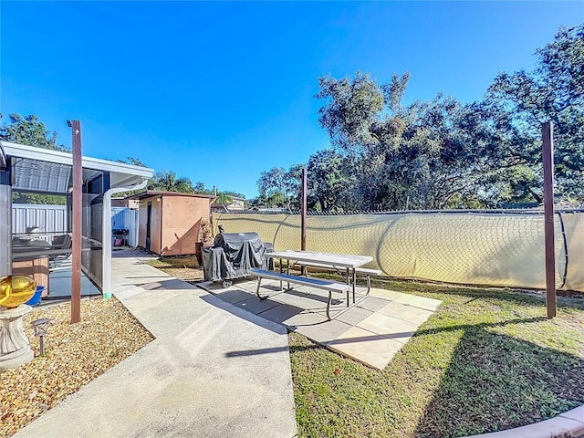 view of patio featuring a storage unit