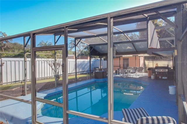 view of swimming pool with a patio and a lanai