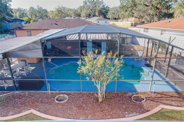 view of pool featuring glass enclosure and a patio