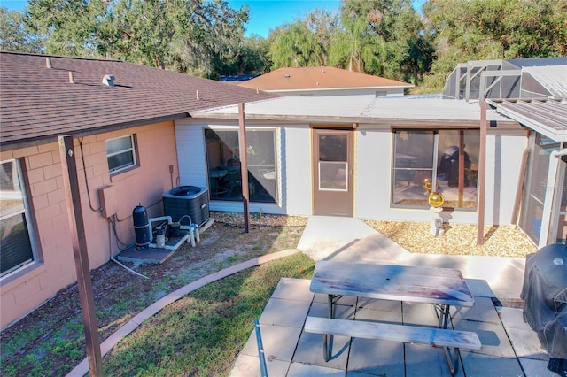 rear view of house with a patio area and central AC