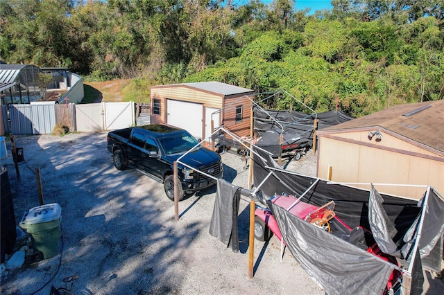 exterior space featuring a garage and an outdoor structure