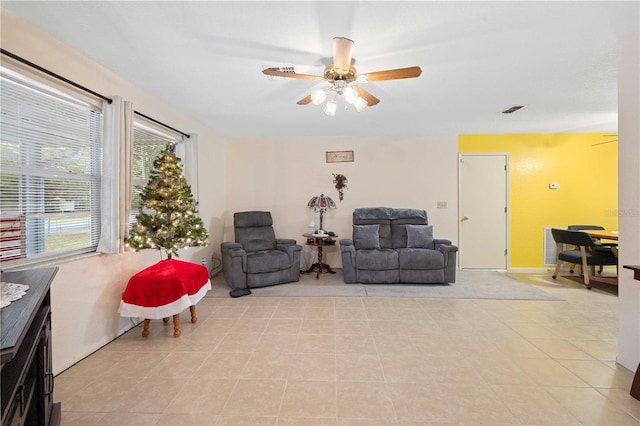 sitting room with ceiling fan and light tile patterned flooring