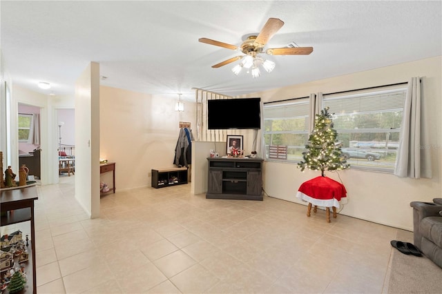 tiled living room featuring ceiling fan